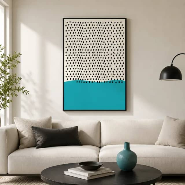 Dots Over Turquoise Wave canvas in a black frame above a modern sofa