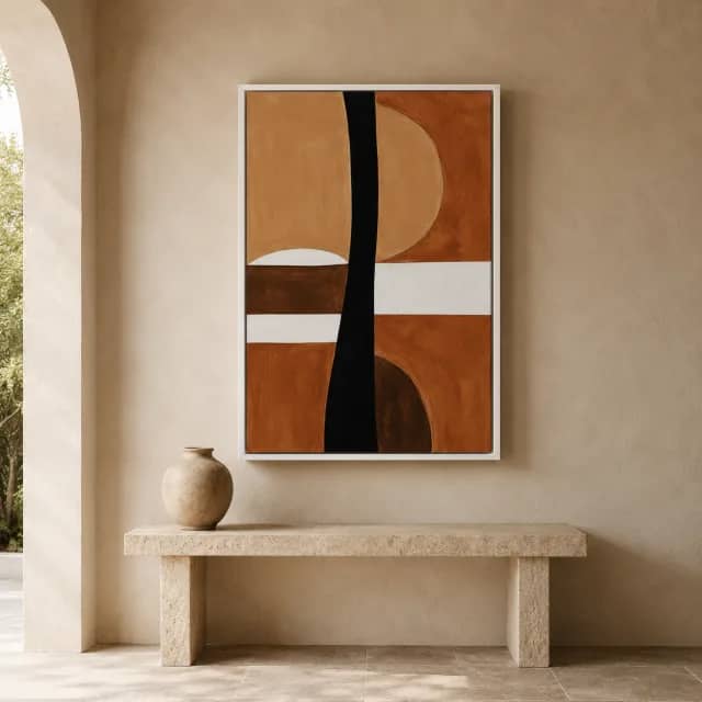 Black Earthen Axis in a white floater frame above a stone console in a warm entryway