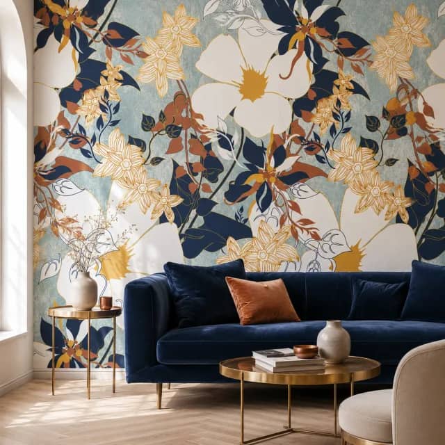 Blue botanical wallpaper behind a navy sofa in a lounge