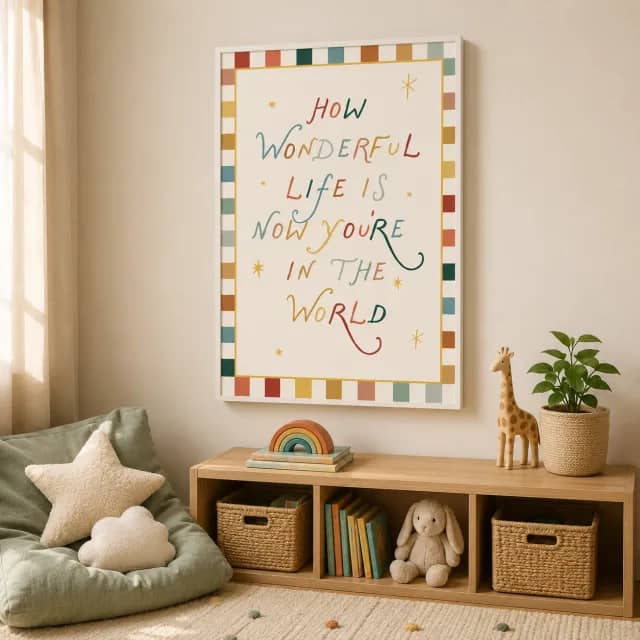 Kids quote wall art in a white floater frame above a calm nursery reading shelf