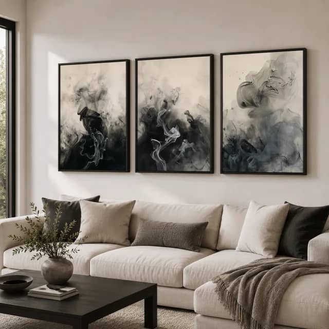 Smoke Stillness shown as three black framed panels above a light sofa in a calm living room