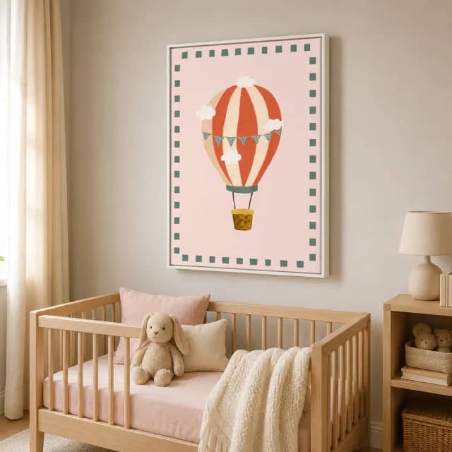 Pink Balloon Journey artwork above a wooden crib with a white floater frame