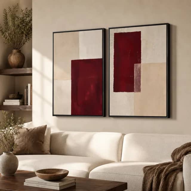 Quiet Burgundy Rhythm two-piece wall art in black frames above a sofa in a warm living room