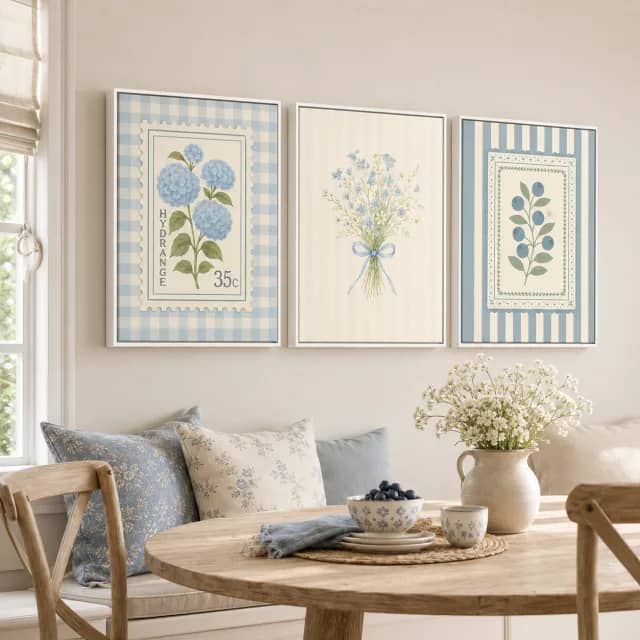 Quiet Blue Garden triptych above a breakfast nook in white floater frames