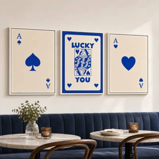 Blue Lucky Hand on a dining or cafe wall with white frames and soft light