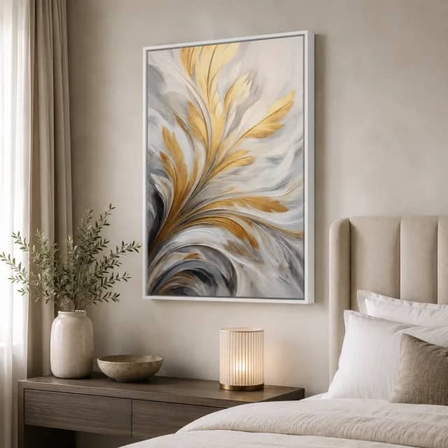Gilded Leaf Drift in a white floater frame beside an elegant boutique bed