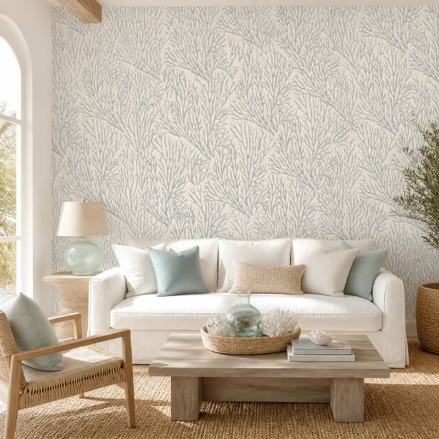 Blue coral mural behind a white sofa in an airy coastal living room