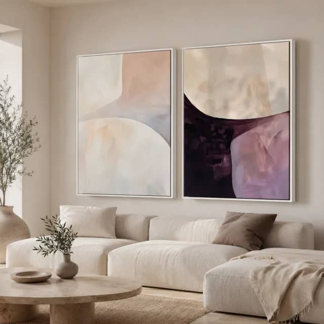 Quiet Curves Pair in white frames above a cream sofa in a calm living room