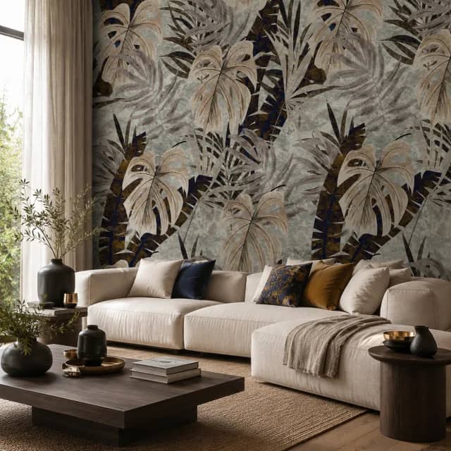 Tropical leaf wallpaper behind a light sofa in a modern living room